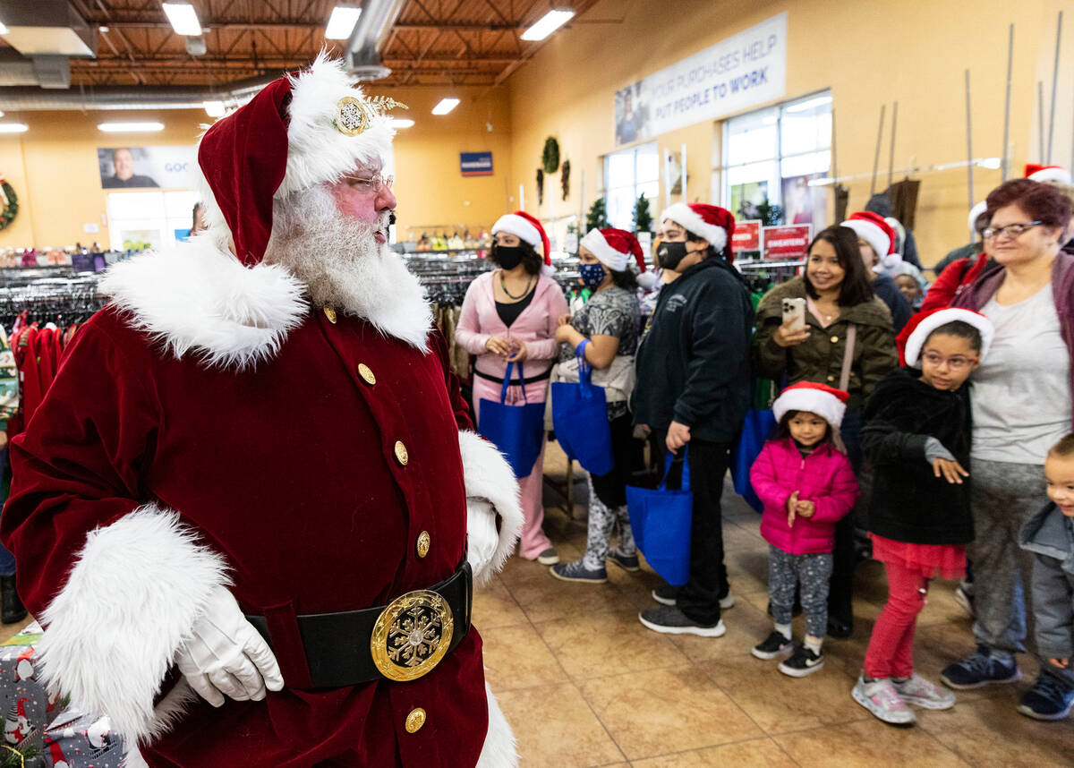 Shoppers watch as Santa Claus arrives at Goodwill Thrift Store, on Friday, Dec. 2, 2022, in Hen ...