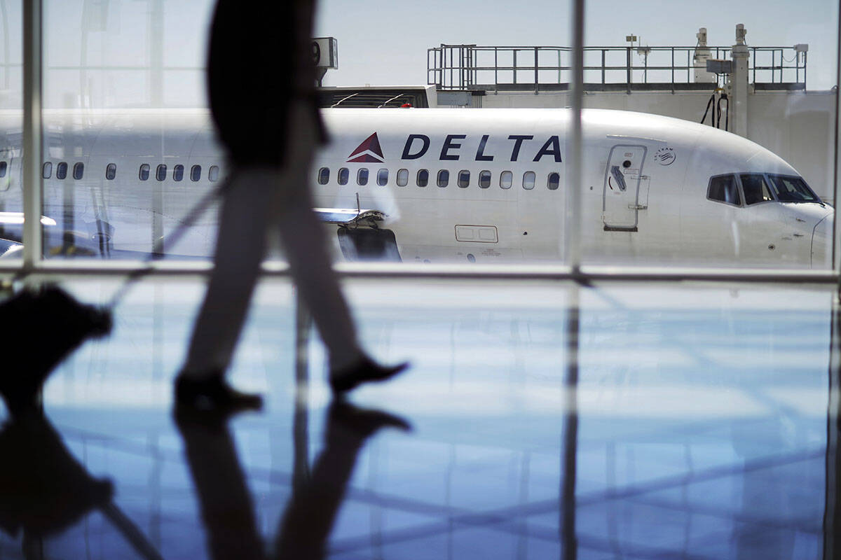 FILE - In this Oct. 13, 2016, file photo, a Delta Air Lines jet sits at a gate at Hartsfield-Ja ...