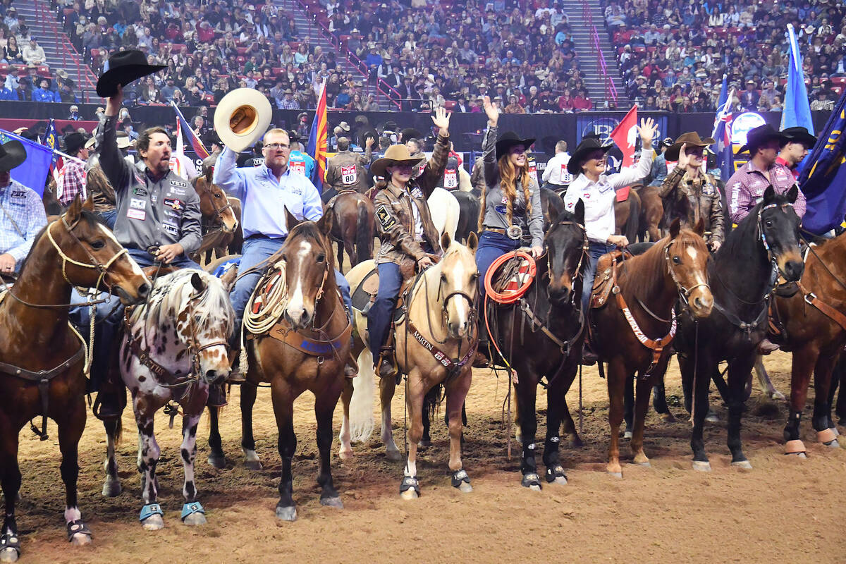 Contestants tip their Resistols to the crowd during the Grand Entry at the 2021 Wrangler NFR at ...