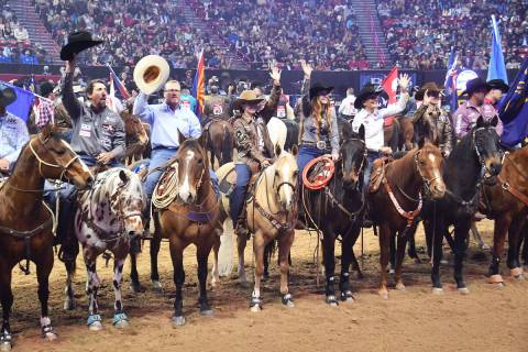 Contestants tip their Resistols to the crowd during the Grand Entry at the 2021 Wrangler NFR at ...