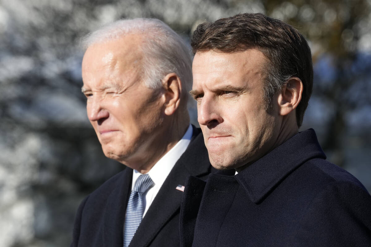 President Joe Biden and French President Emmanuel Macron stand on the stage during a State Arri ...