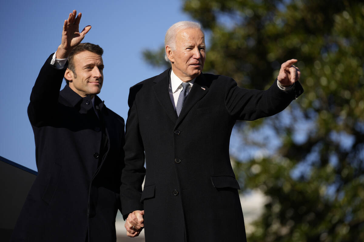 President Joe Biden and French President Emmanuel Macron stand on the stage during a State Arri ...