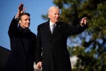 President Joe Biden and French President Emmanuel Macron stand on the stage during a State Arri ...