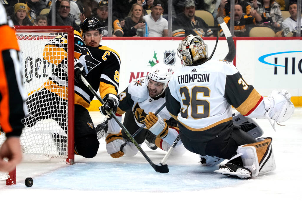 Pittsburgh Penguins' Sidney Crosby (87) tiffs on a loose puck behind Vegas Golden Knights goalt ...