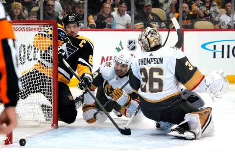 Pittsburgh Penguins' Sidney Crosby (87) whiffs on a loose puck behind Vegas Golden Knights goal ...