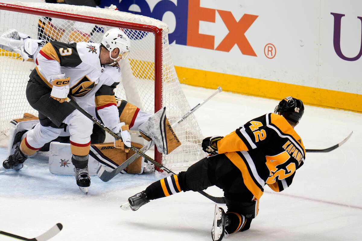 Pittsburgh Penguins' Kasperi Kapanen (42) shoots past Vegas Golden Knights goaltender Logan Tho ...