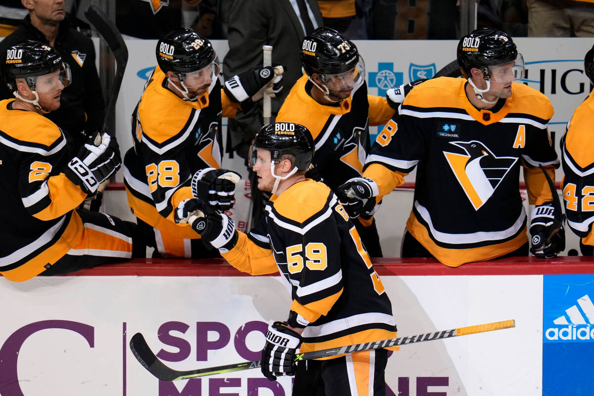 Pittsburgh Penguins' Jake Guentzel (59) returns to the bench after scoring during the third per ...