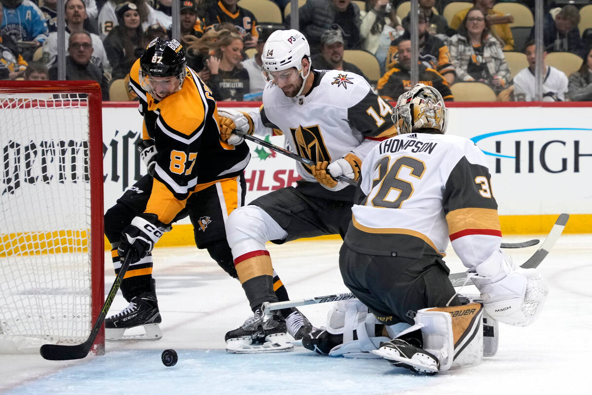 Pittsburgh Penguins' Sidney Crosby (87) goes for the puck behind Vegas Golden Knights goaltende ...