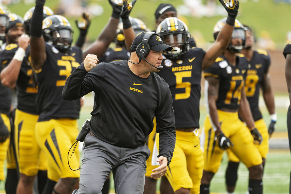 Missouri head coach Barry Odom pumps his fist as players celebrate after a reviewed call result ...