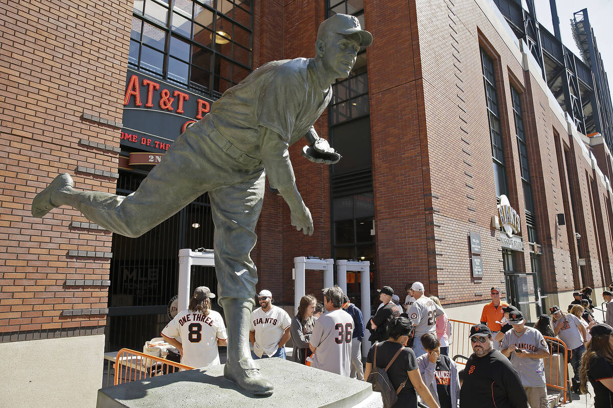 Fans wait to enter AT&T Park by a new statue of Hall of Fame pitcher Gaylord Perry before t ...