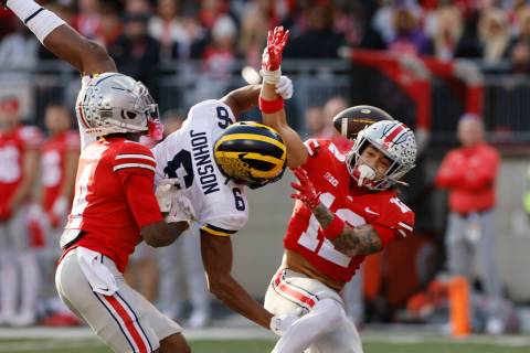 Ohio State defensive back Lathan Ransom, right, interferes with Michigan receiver Cornelius Joh ...