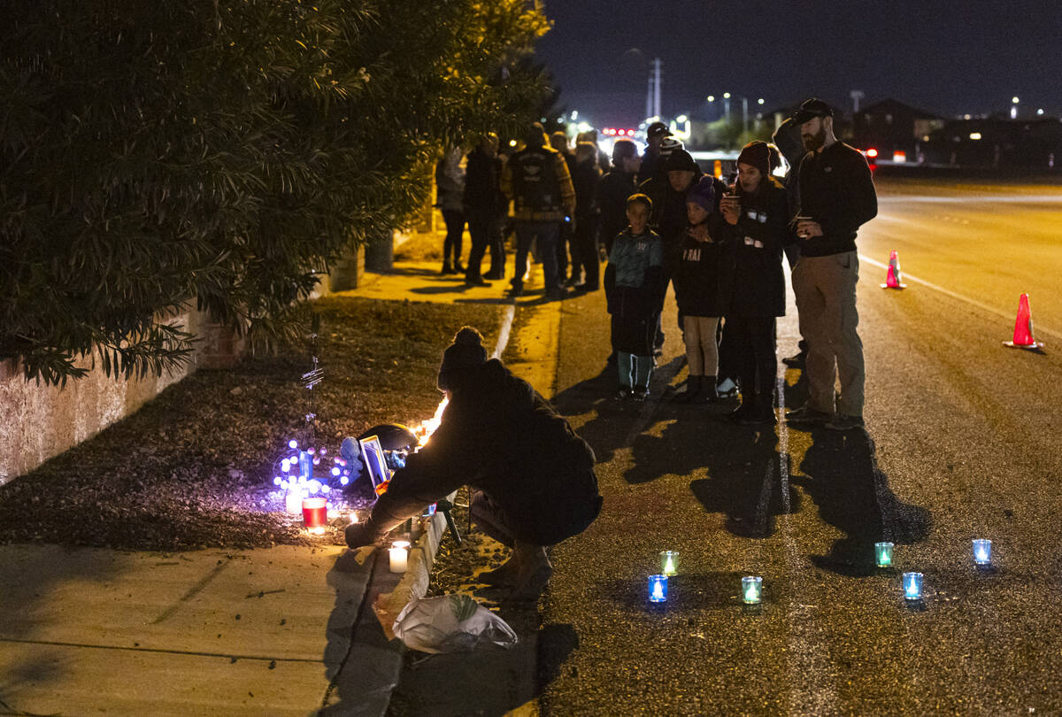 Family and friends place candles at the scene of a vigil where 28-year-old motorcyclist Rhianno ...