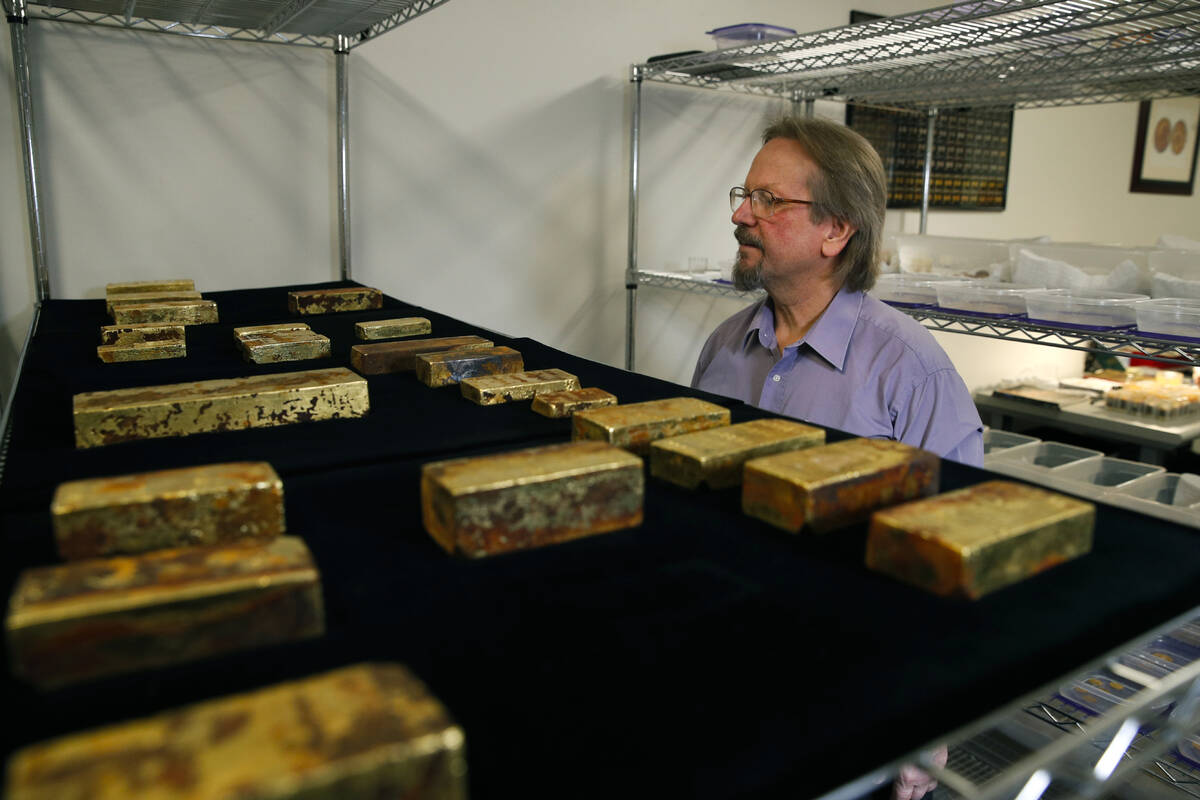 FILE - Chief scientist Bob Evans looks at gold bars recovered from the S.S. Central Americ ...