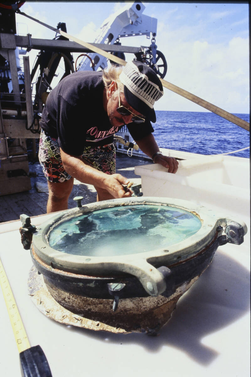 In this 1991 photo provided by the California Gold Marketing Group scientist Bob Evans examines ...