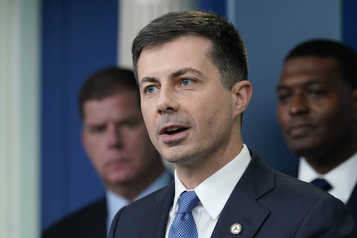 Transportation Secretary Pete Buttigieg, center, speaks during a briefing at the White House in ...