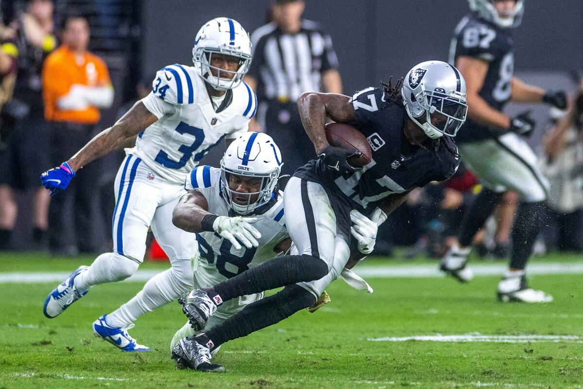 Raiders wide receiver Davante Adams (17) looks for more yards after a catch as Indianapolis Col ...