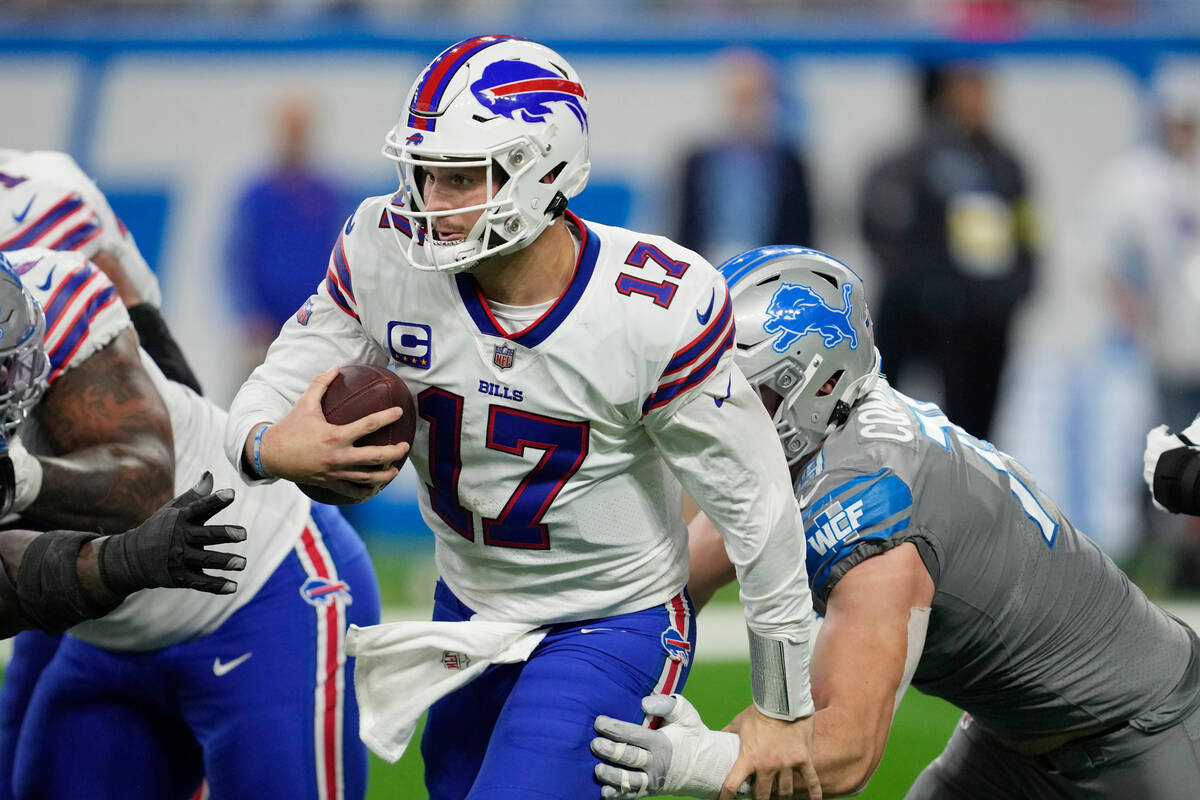 Buffalo Bills quarterback Josh Allen scrambles during the second half of an NFL football game a ...
