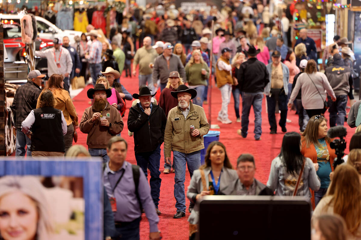 Shoppers browse booths during Cowboy Christmas at the Las Vegas Convention Center Thursday, Dec ...
