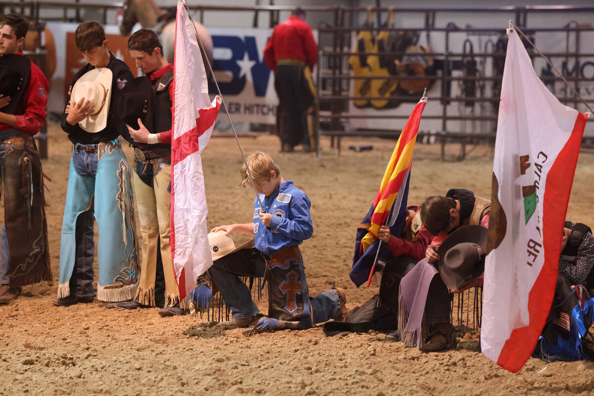 Competitors pray before the YETI Junior World Finals 2022 rodeo during Cowboy Christmas at the ...