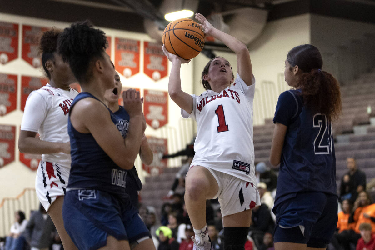 Las Vegas’ Layla Faught (1) shoots against Spring Valley’s Mia Ervin, left, and C ...