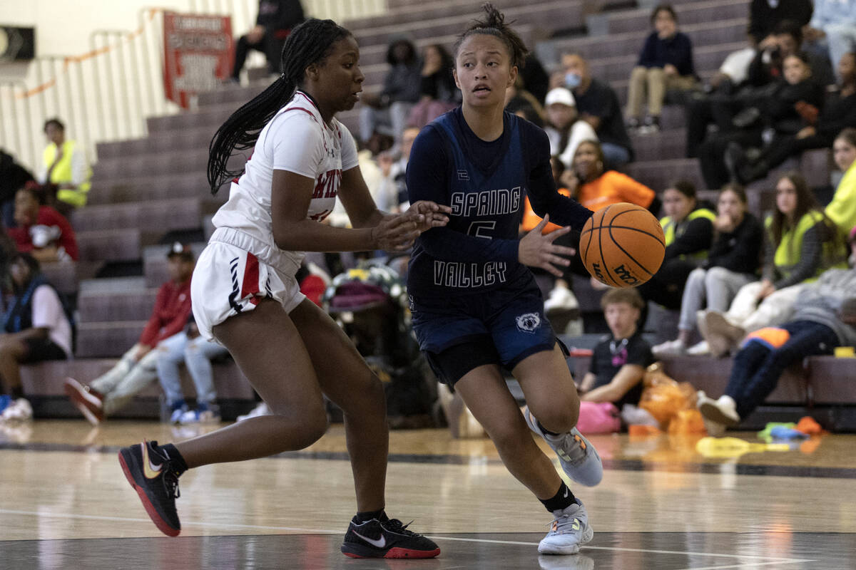 Spring Valley’s Gia McFadden (5) dribbles around Las Vegas’ Jaidyn Savoy, left, d ...