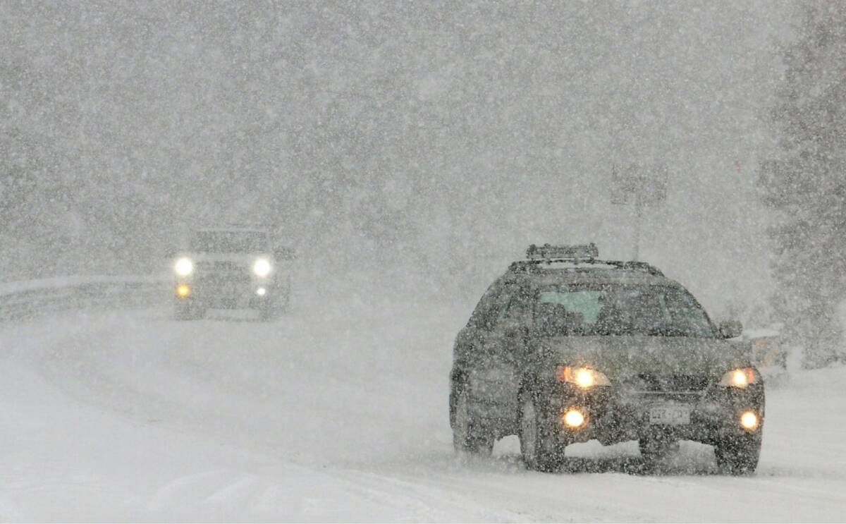 Cars slowly make their way as heavy snow falls on the Mt. Rose Highway near Reno, Nev., on Dec. ...