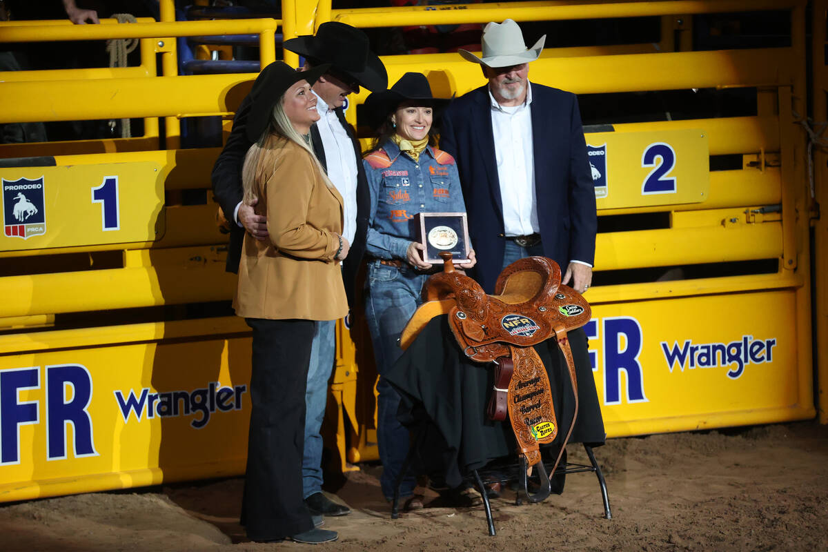 Jordon Briggs of Tolar, Texas, third from left, is announced the winner in the barrel racing du ...