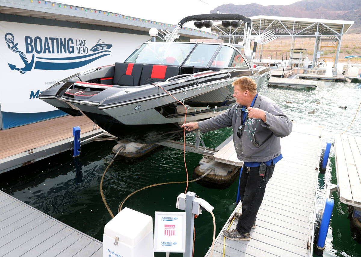 Maintenance worker Paul McBerty tends to a boat at Lake Mead Marina near Boulder City Monday, D ...