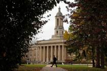 FILE- In this Nov. 9, 2017, file photo people walk by Old Main on the Penn State University mai ...