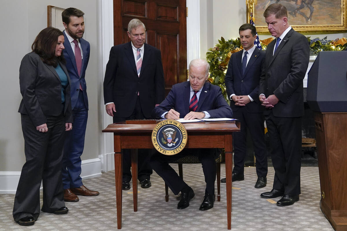 President Joe Biden signs H.J.Res.100, a bill that aims to avert a freight rail strike, in the ...