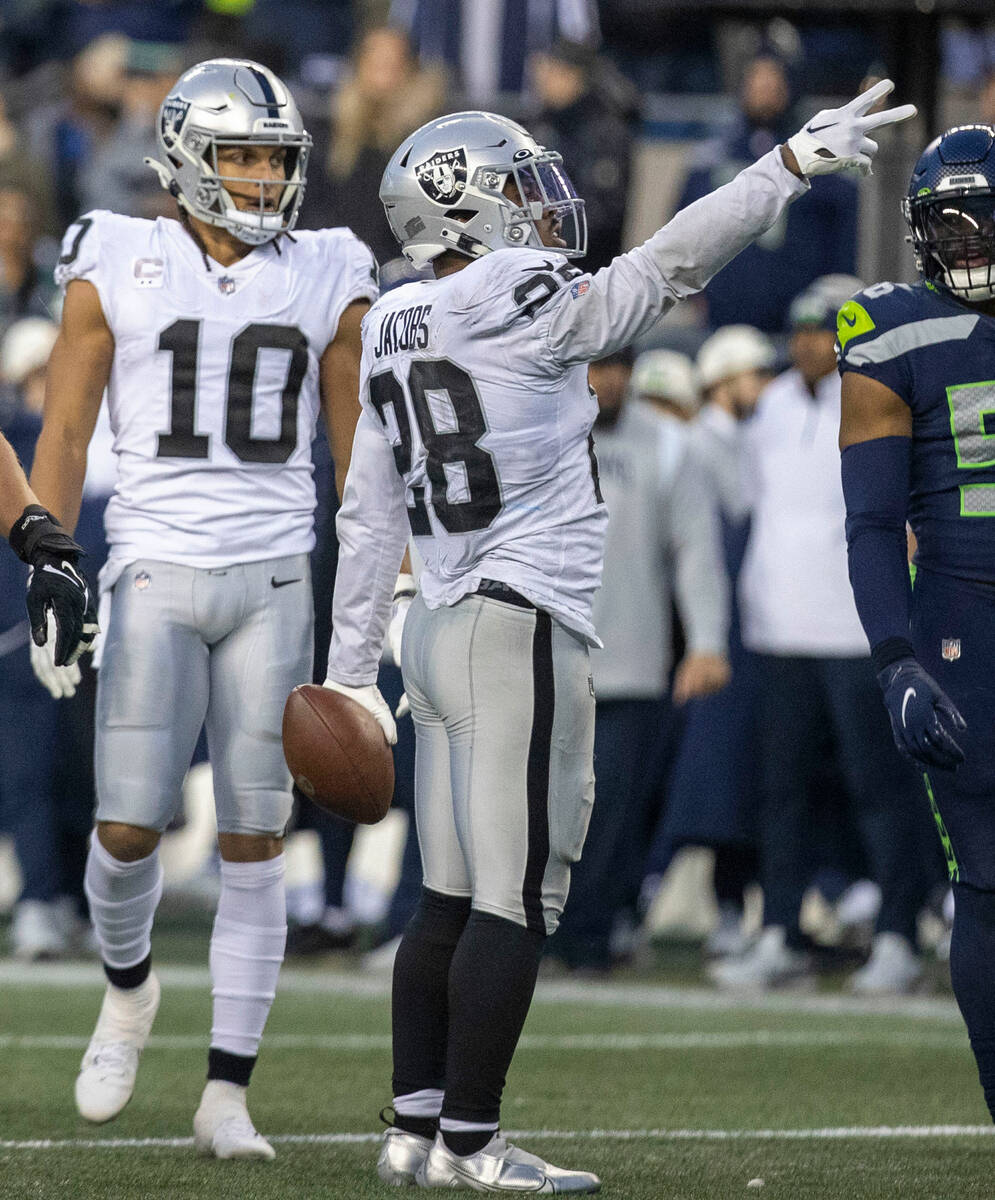Raiders running back Josh Jacobs (28) signals for a first down during overtime of an NFL game a ...