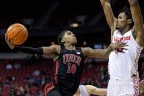 UNLV Rebels guard Keshon Gilbert (10) shoots against Dayton Flyers forward DaRon Holmes II (15) ...