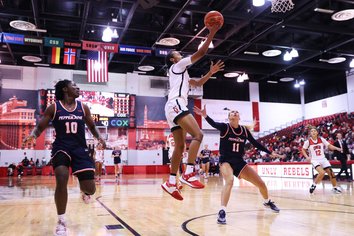 Pepperdine's Jane Nwaba (10) and Helena Friend (11) look on as UNLV's Justice Ethridge (11) tak ...