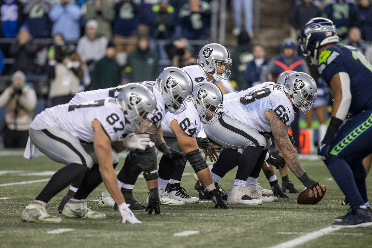 Raiders quarterback Derek Carr (4) lines up behind center Andre James (68) during overtime of a ...