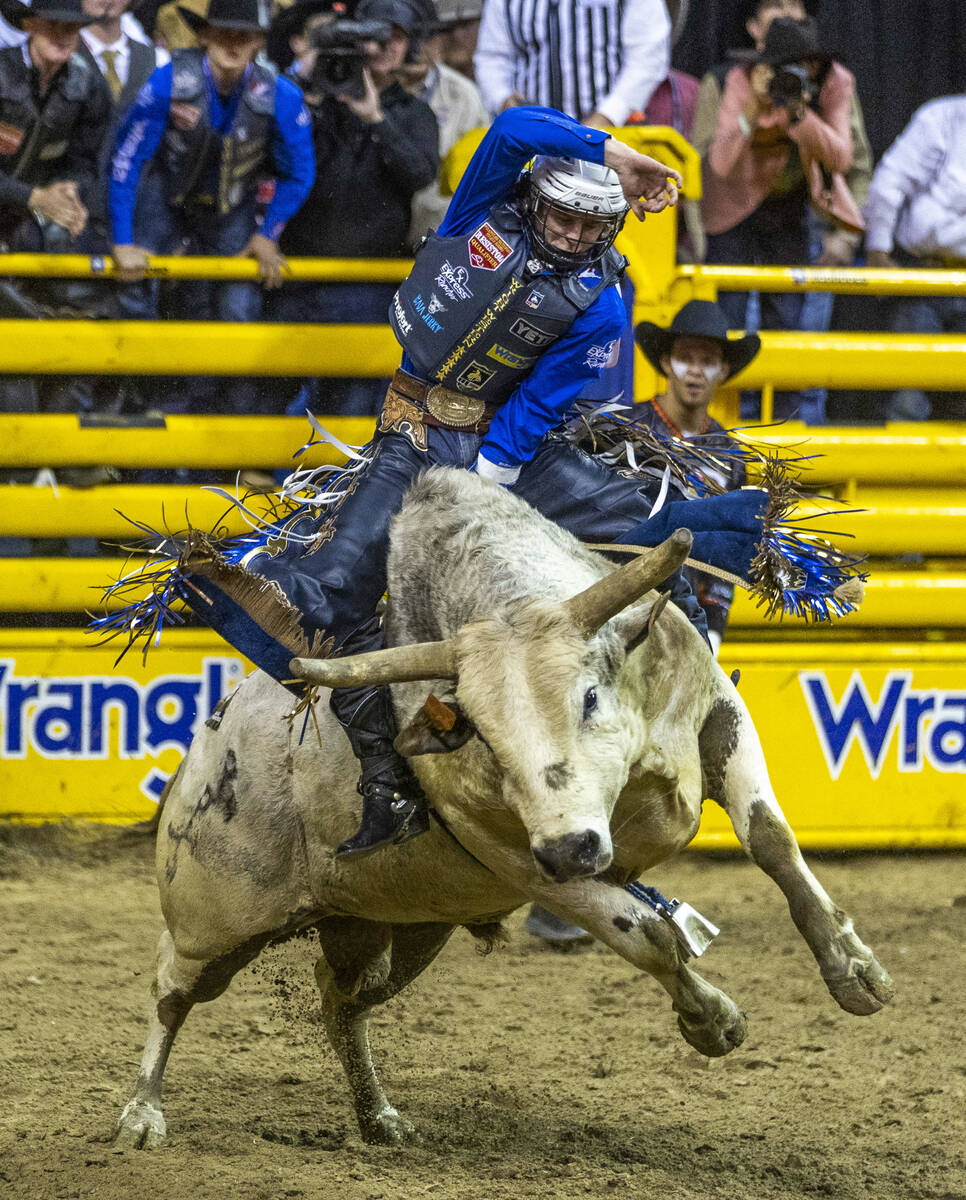 Stetson Wright of Milford, Utah, rides Pookie Holler to a winning score in Bull Riding during t ...