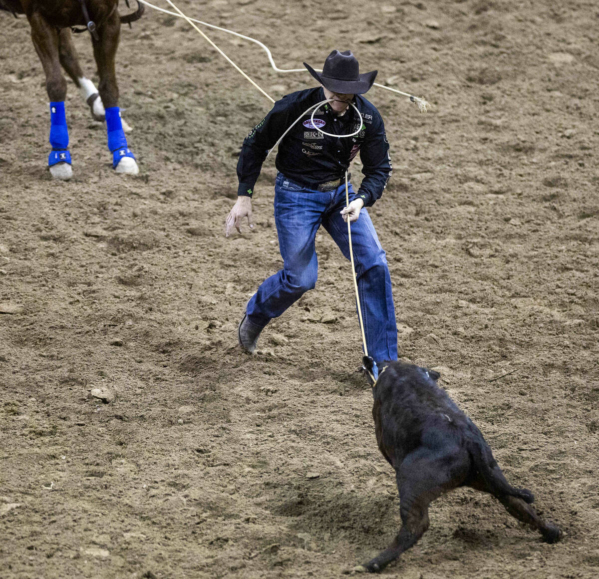Marty Yates on Stephenville, TX., works the rope to his calf on his winning  ride during Tie-Dow …