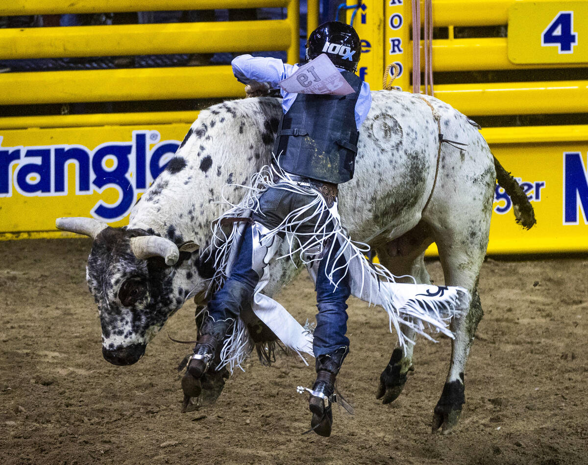 Trey Kimzey of Strong City, OK., attempts to stay on a bull as he competes during Bull Riding i ...