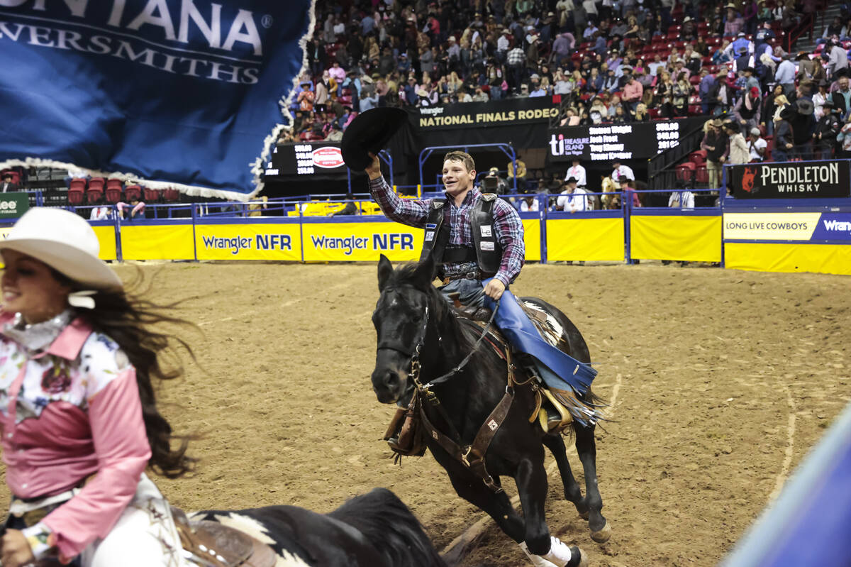 Tristen Hutchings, of Monteview, Idaho, celebrates after coming out on top in bull riding in th ...