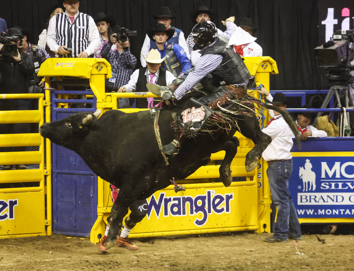 Trey Holston, of Fort Scott, Kan., rides Time for Magic while competing in bull riding during t ...
