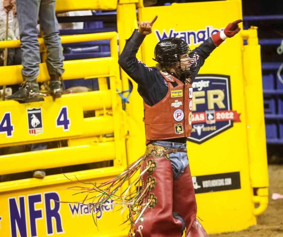 Josh Frost, of Randlett, Utah, celebrates after riding OLSTubs Sunny while competing in bull ri ...