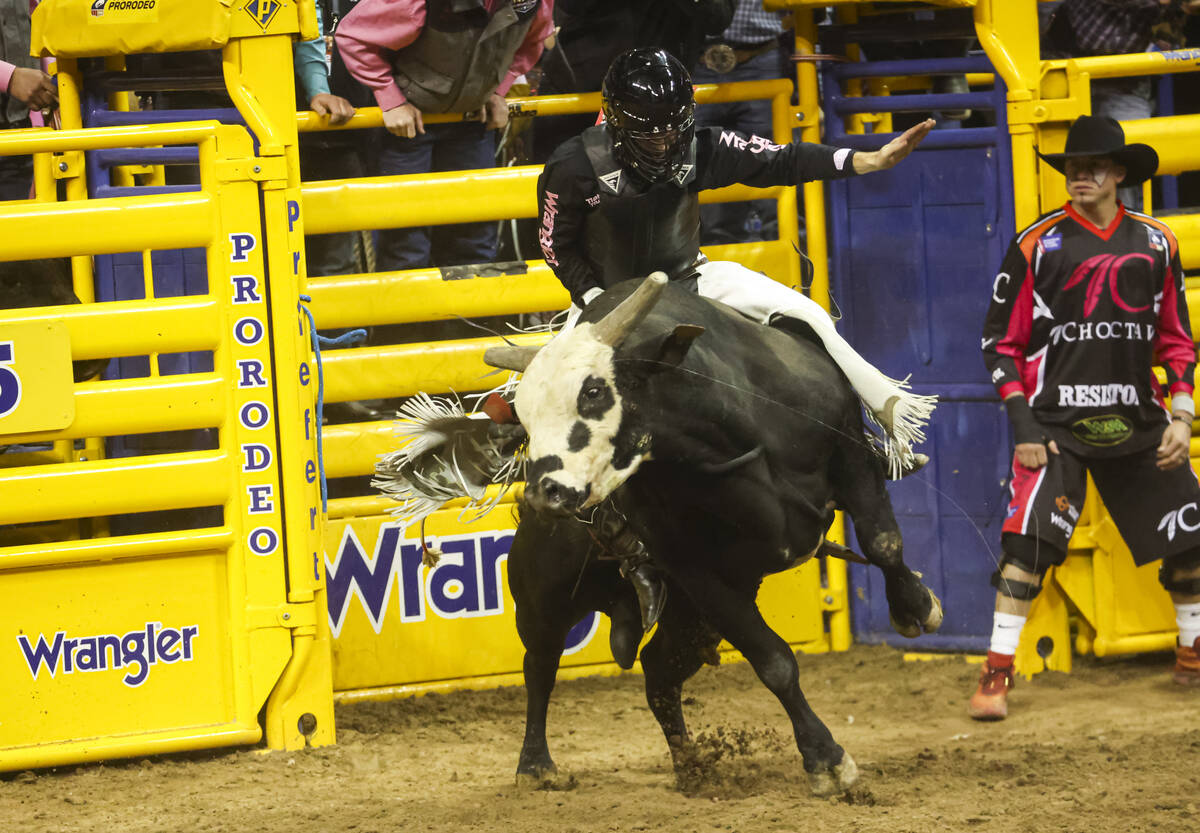 Trey Kimzey, of Strong City, Okla., rides Crash Cart while competing in bull riding during the ...