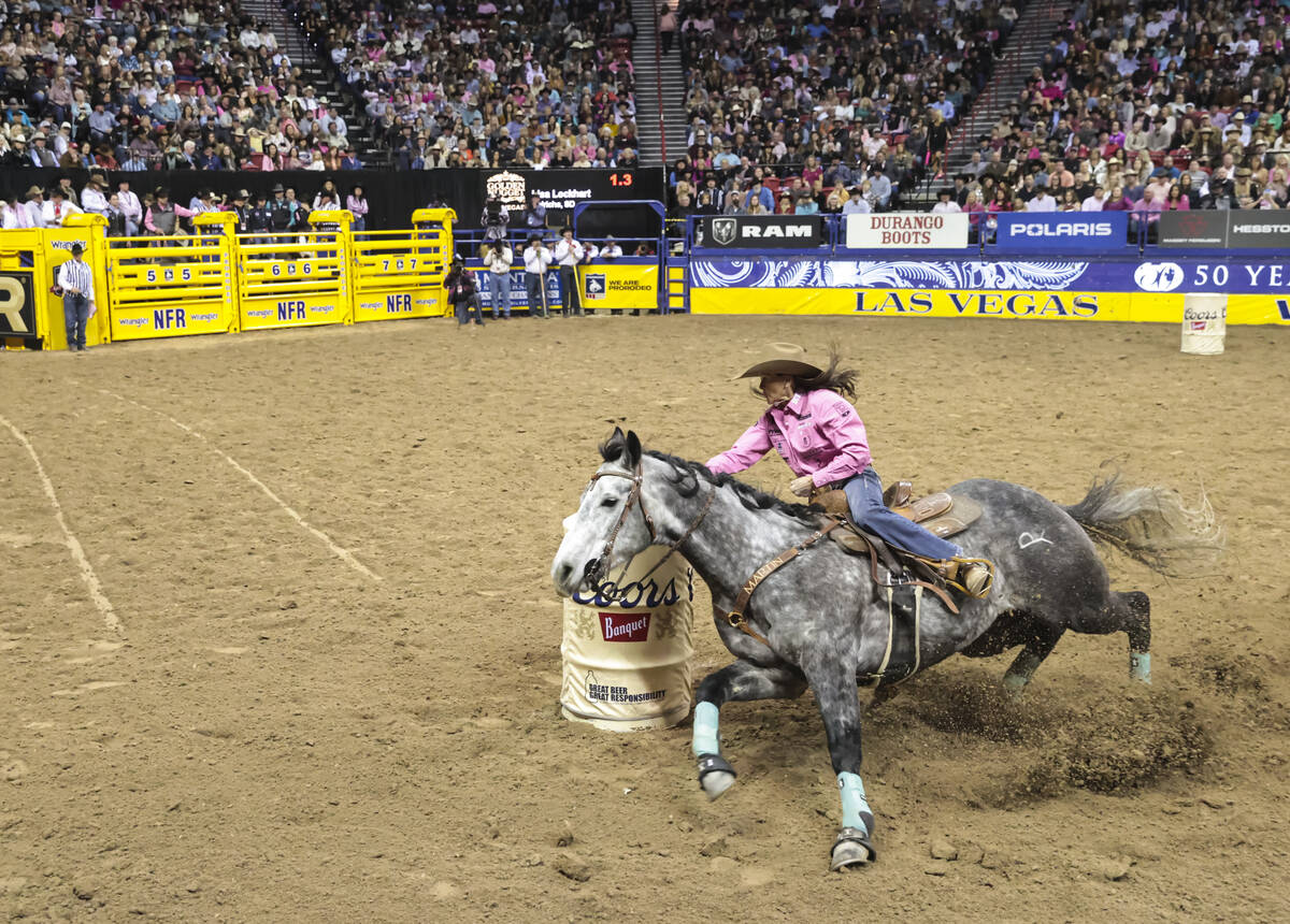 Lisa Lockhart, of Oelrichs, S.D., competes in barrel racing during the fifth go-round of the Na ...