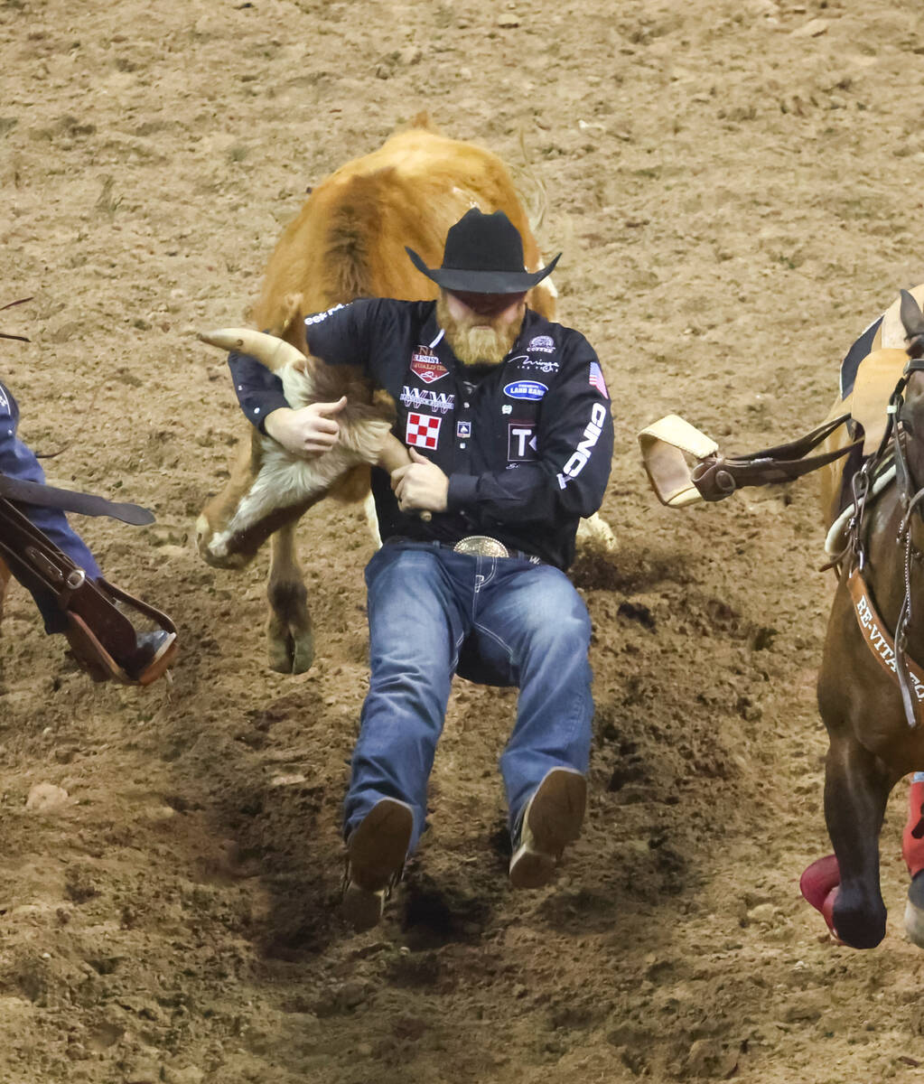 Will Lummus, of Byhalia, Miss., competes in steer wrestling during the first night of the Natio ...