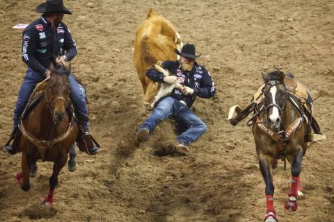 Will Lummus, of Byhalia, Miss., competes in steer wrestling during the first night of the Natio ...