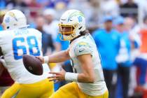 Los Angeles Chargers quarterback Justin Herbert rolls out against the Arizona Cardinals during ...