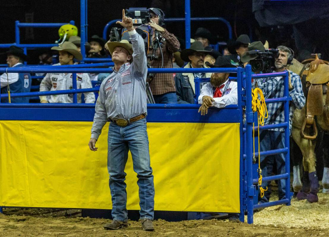 Hunter Cure of Holliday, TX., celebrates his winning round in Steer Wrestling during the Nation ...