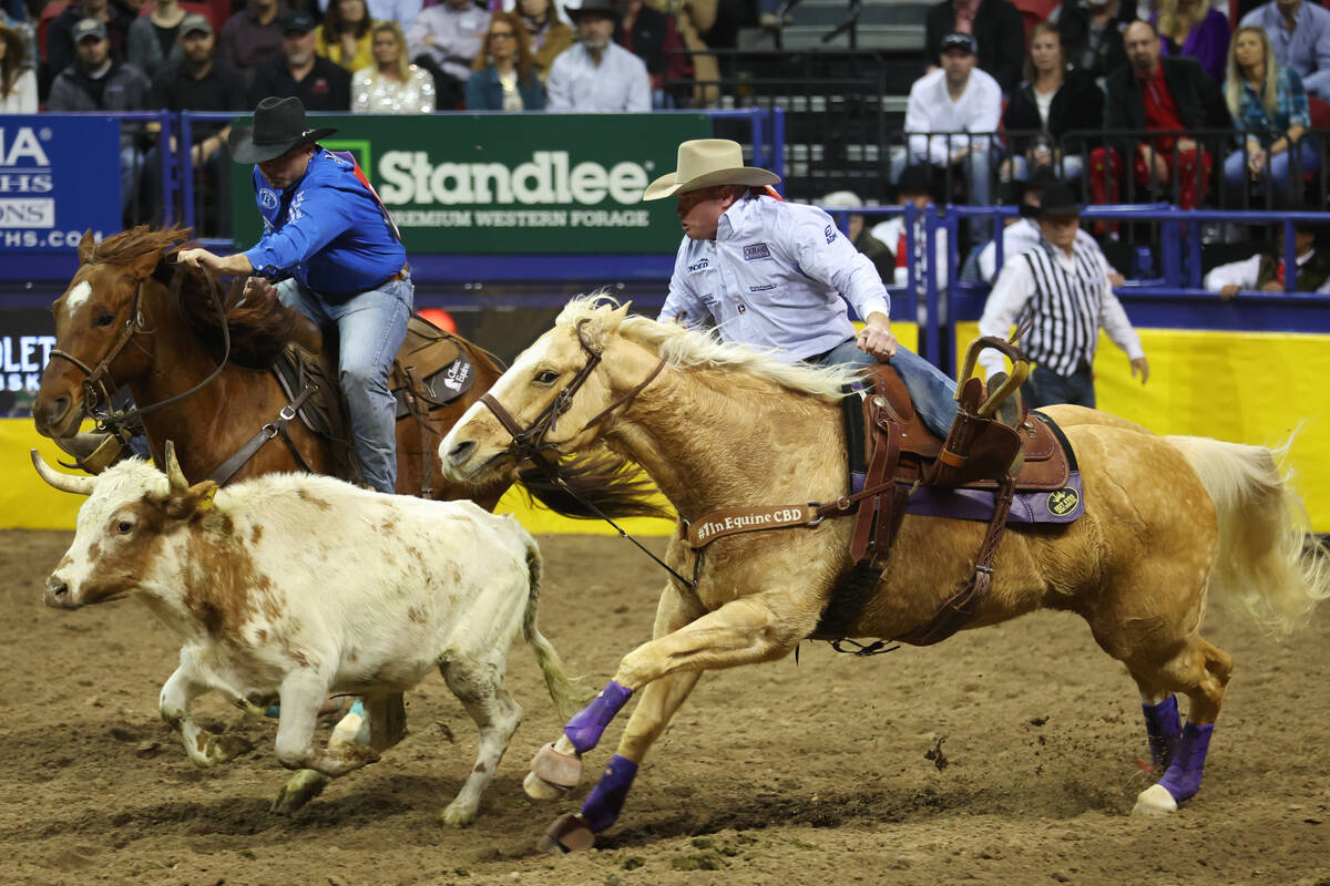 Hunter Cure, right, competes during the steer wrestling event in the 64th Wrangler National Fin ...