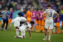 U.S. players react at the end of the World Cup round of 16 soccer match between the Netherlands ...