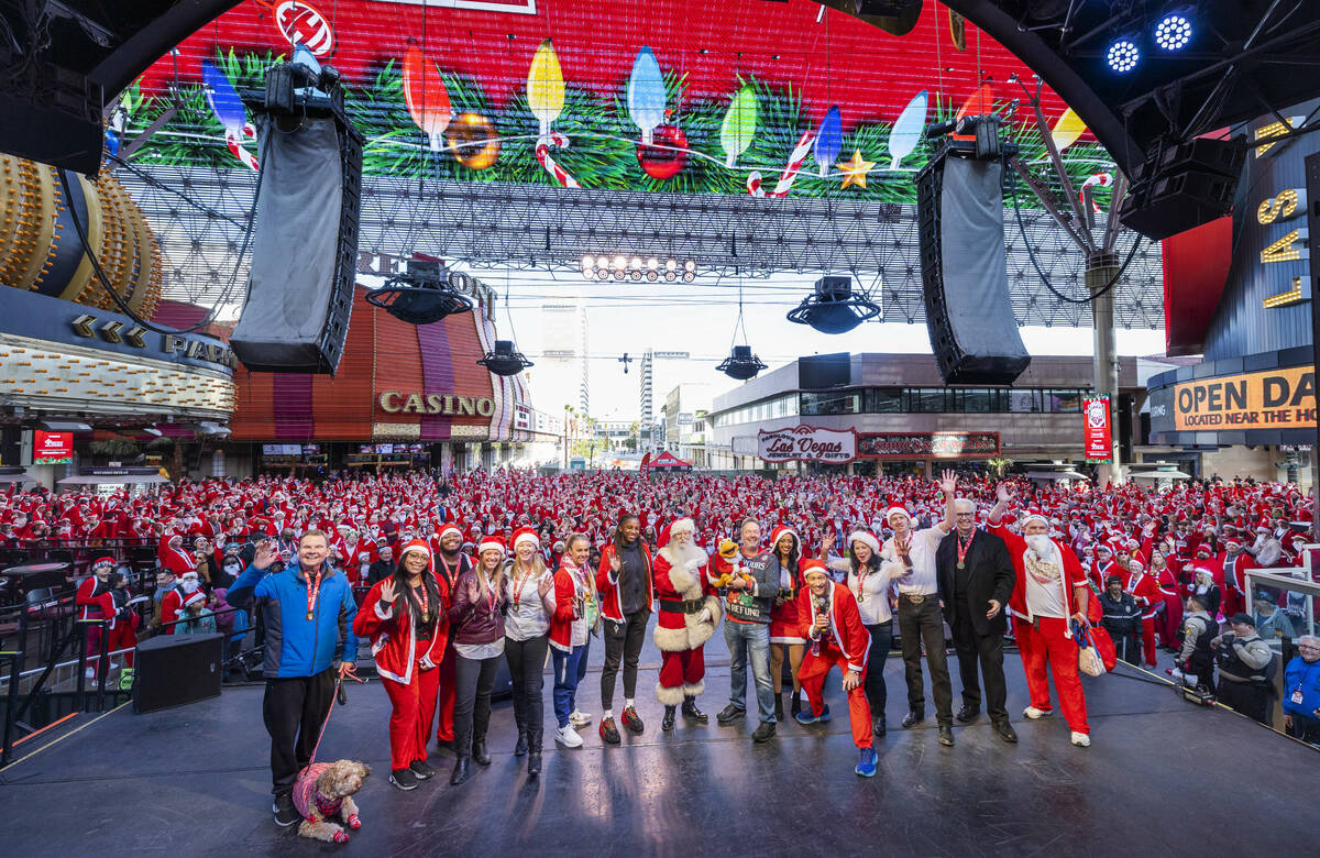 Invited guests and performers gather for a photo with the crowd during the pre-race entertainme ...