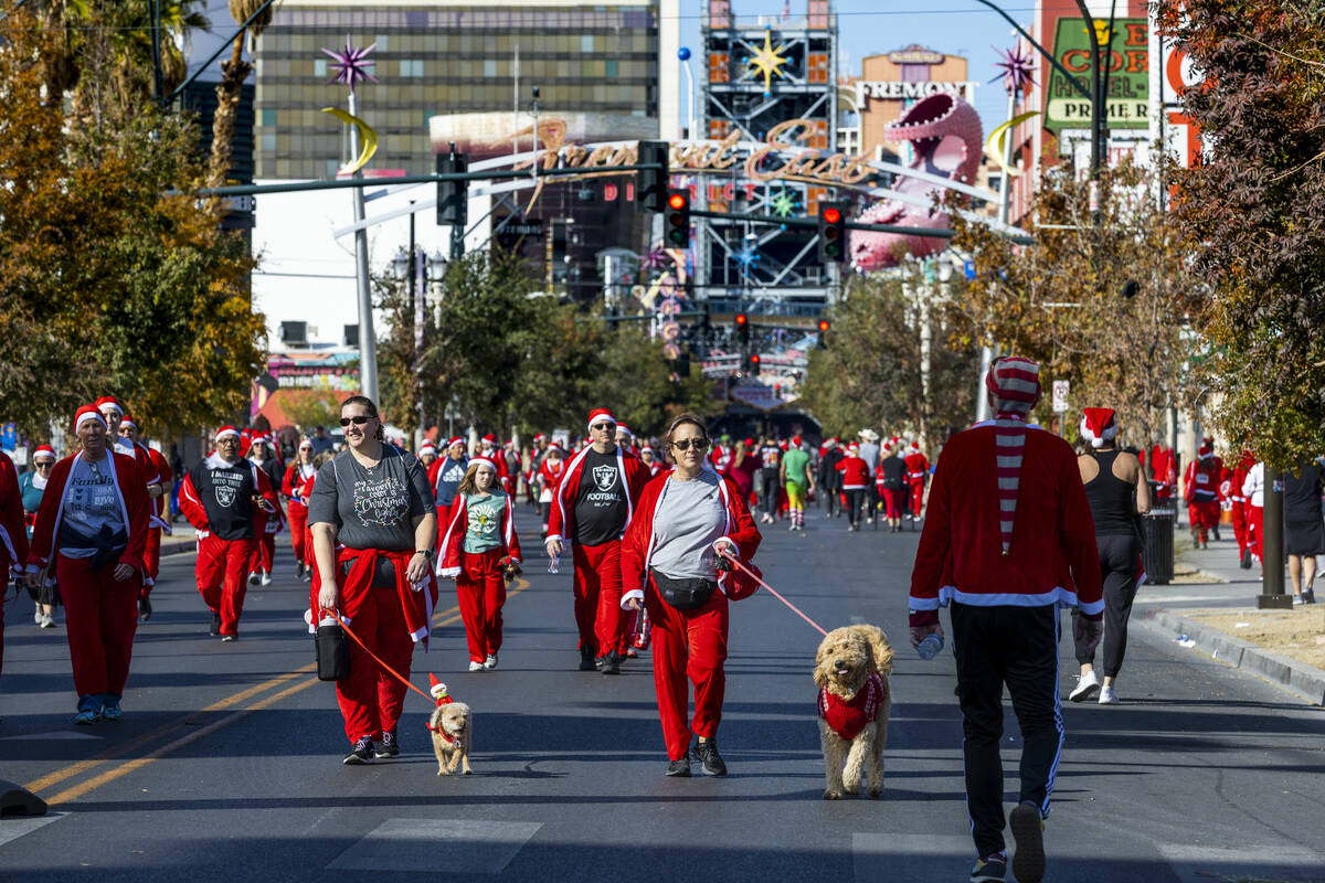 Participants move along Fremont Street near the finish at the Llama Lot during the 18th Annual ...